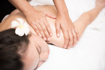 Obraz na płótnie Canvas Young woman receiving salt massage in spa salon