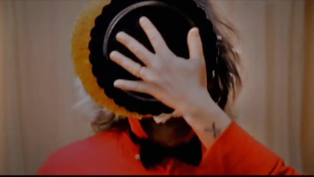 Analog capture (intentional heavy distortion fx): an extrovert man receives a whipped cream pie in the face while dancing. Funny classical slapstick comedy gag.
