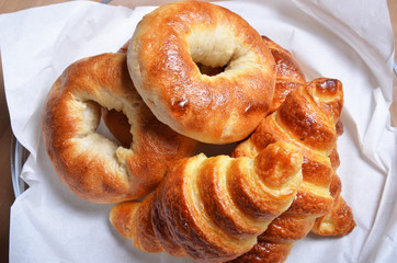 Closeup of a heap of bagels and croissants