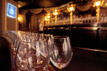 Empty wineglasses in row on bar before evening party