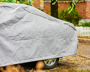 Closeup of car under protective cover from adverse weather conditions