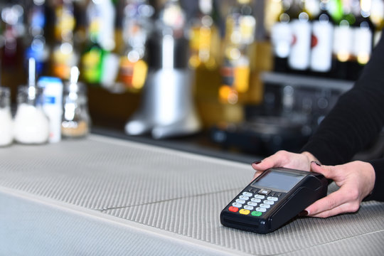 Electronic finance and shopping. Cashiers hand holds credit card reader