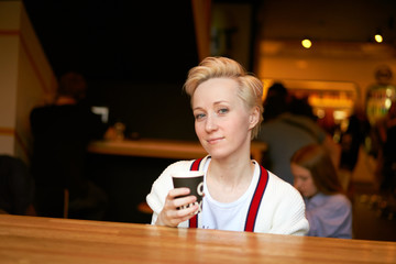 girl drinking coffee in a cafe