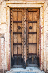 Antique rustic ancient wooden door. Architectural element.