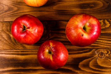 Ripe red apples on the wooden table. Top view