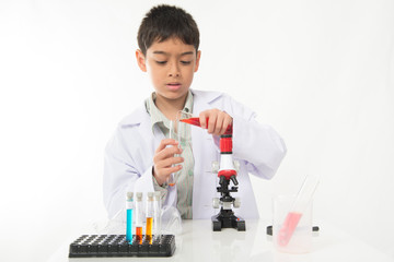Little boy with flasks  and microscpope equipment for chemistry science class