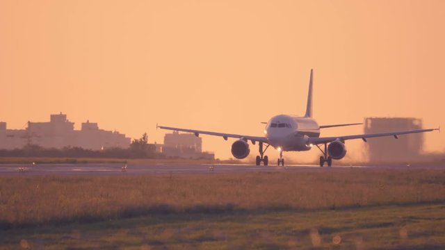 Airplane takes off at dawn. Aircraft takes off at sunset. 