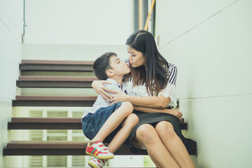 Single mother walking together on the step in the house with happy smile