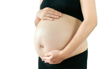 Pregnant woman touching her belly with hands isolate on white background