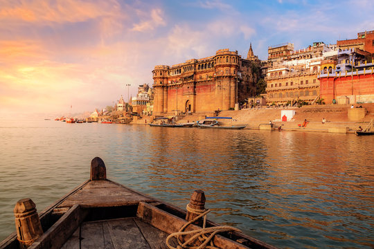 Varanasi ancient city architecture at sunset as viewed from a boat on river Ganges.