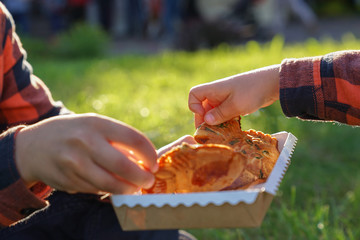 Kids hands holding Japanese Taiyaki fish-shaped cake teared