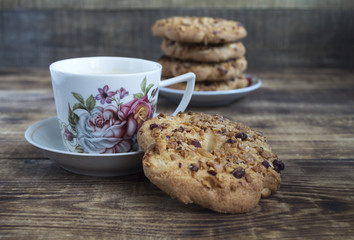 Cup of coffee and cookies on a wooden table. Still-life in a rustic style.
