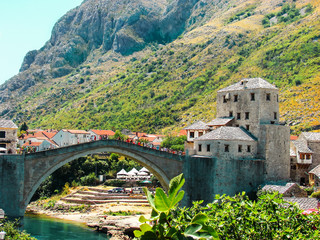 Scenic landscape of Mostar city and old bridge across Neretva river in a lovely summer day. Bosnia...