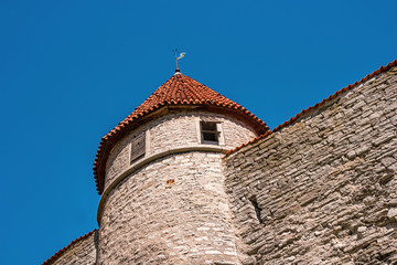 Fototapeta na wymiar Medieval fortress with towers in the Old town. Tallinn, Estonia. The towers have a red tiled roof