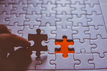 Jigsaw with one piece missing revealing