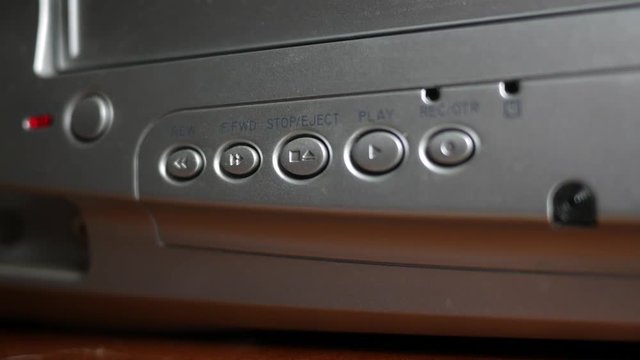 Playing or watching a VHS Tape in a player - pressing button