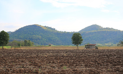 Landscape view after harvesting with old cottage mountain background.