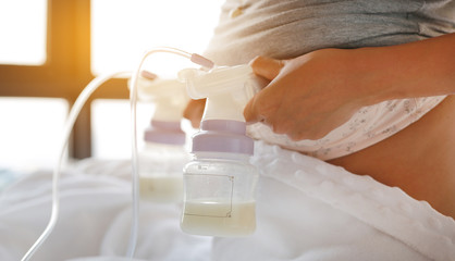 Mother using automatic breast pump.
