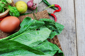Kale and eggs on wooden.