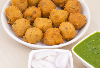 Indian Spicy Street Food Dal Vada Also Know as Moong Dal Vada, Pakoda, Pakode, Pakore, Moong Vada, Pakora or Bhajiya Served with Green Chutney or Onion