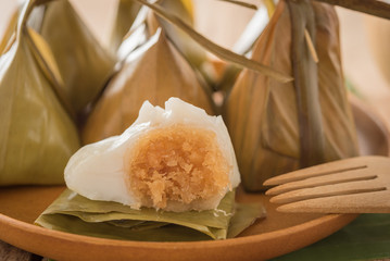 thai dessert. steamed flour with coconut filling  packaging from banana leaf (kanom sai sai)
