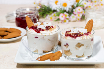 dessert in a glass with cookies, cream and jam