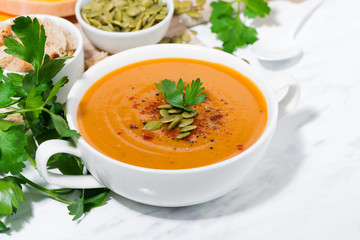 fresh soup of pumpkin and lentils on white background