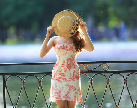 girl in a dress and in a straw hat