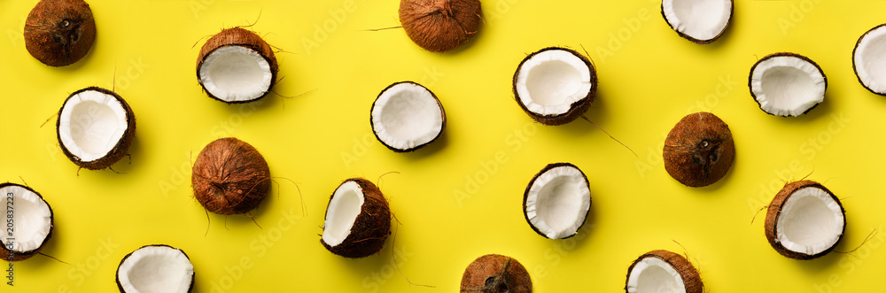 Wall mural pattern with ripe coconuts on yellow background. top view. copy space. pop art design, creative summ