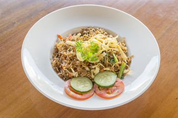 Fried rice nasi goreng with chicken and vegetables on a plate. Indonesian cuisine.