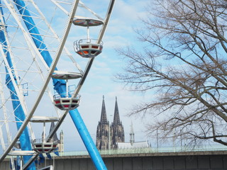 Close up ferris wheel in Cologne with the dome in the background