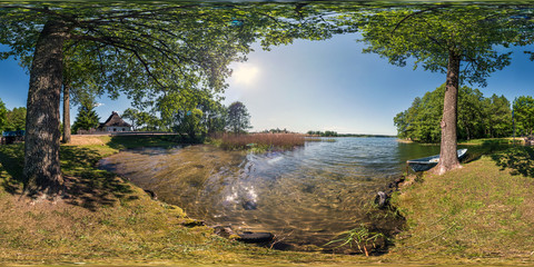 full seamless panorama 360 by 180 angle view on the shore of huge forest lake with a boat in sunny summer day in equirectangular projection, skybox VR virtual reality content