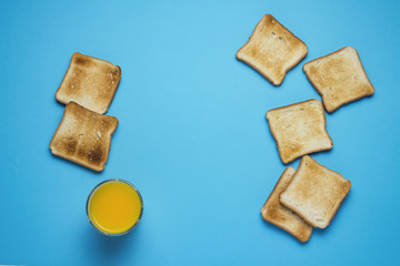 Toasts and orange juice on a blue background.