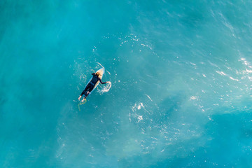 Surfer in the ocean, top view