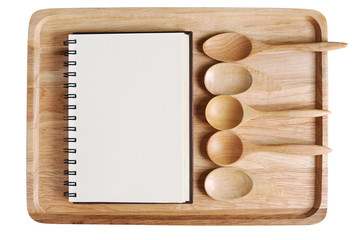 empty wood plate with spoon collection and dirary