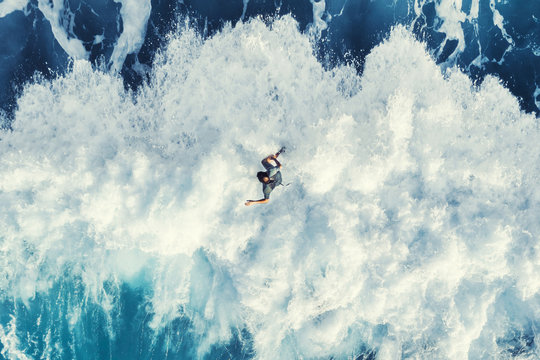 Surfer on the big wave, top view