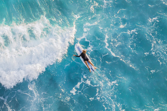 Surfer in the ocean, top view