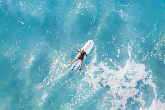 Surfer in the ocean, top view