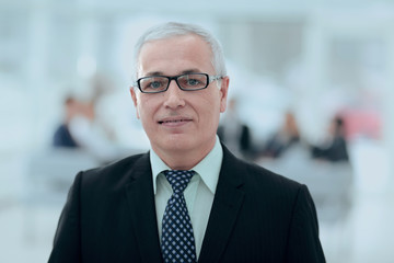 Naklejka premium close up portrait of senior businessman in office