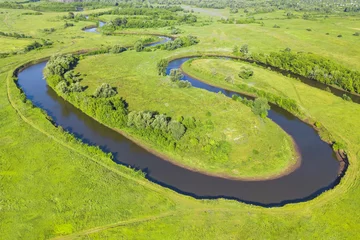 Stof per meter Top view of a winding river in a green valley © watman