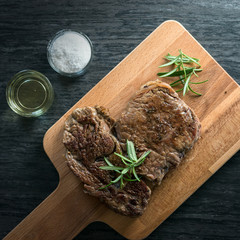 Grilled beef steak with spices on cutting board