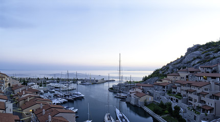 High point of view of beautiful Porto Piccolo (Small harbor) and its dock with sailboats and yachts...