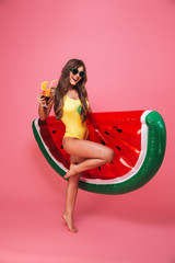 Full length portrait of a cheerful young woman