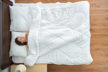 The woman sleeping on the bed. view from above
