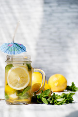 Lemonade with blue umbrella on white background.