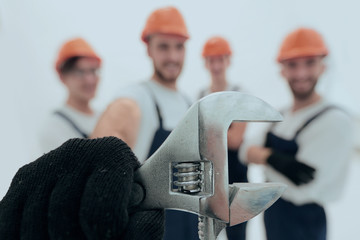 closeup. the wrench in the hands of the builders