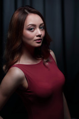 Fashionable young beautiful woman in a red dress