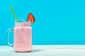 Healthy smoothie with fruits and milk, blended strawberry milkshake in jar, drink with vitamins and...