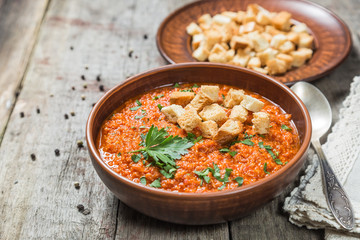 Tomato soup on a table of old wooden boards. Copy-space.
