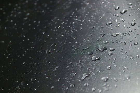 Rain Drops On The Window Or Car Roof In Rainy Day. Selective Focus With Low Key. Background Concept.